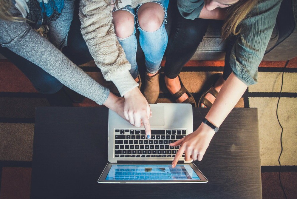 people around a laptop