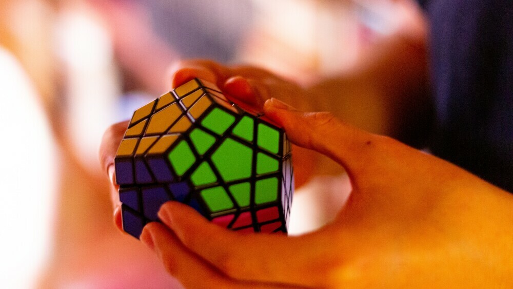 someone holding a rubix cube