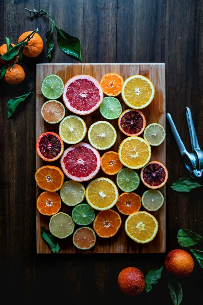 different citrus fruit cut in half