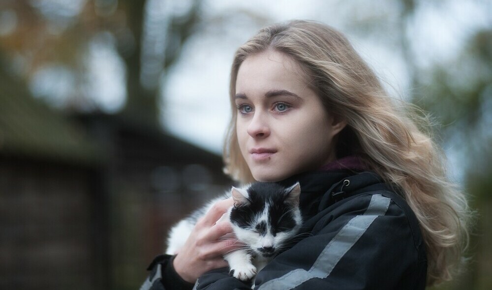 Girl outside holding cat