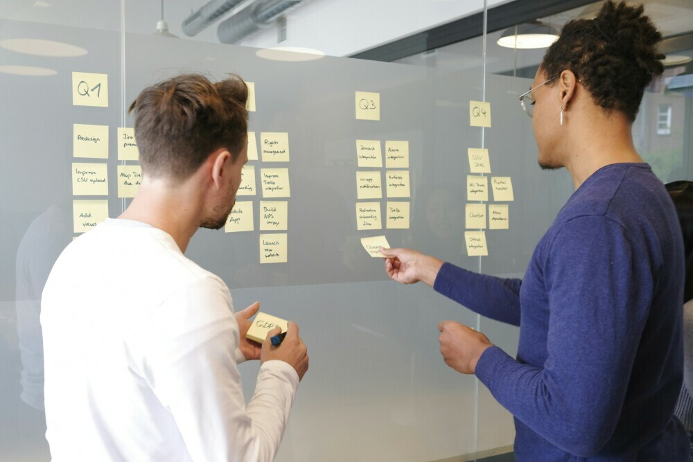 Two people creating a task board