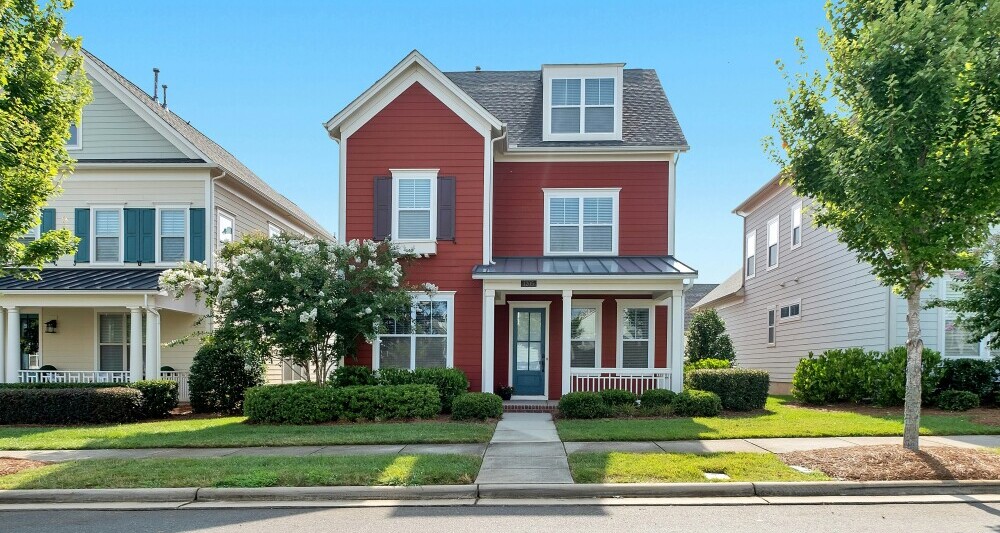 red two story home in neighborhood