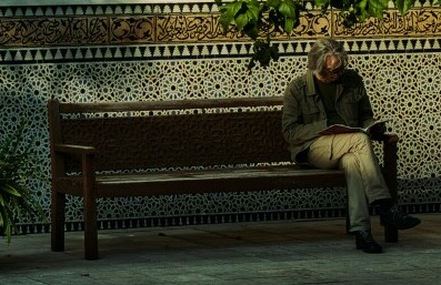 reading outdoors on a bench