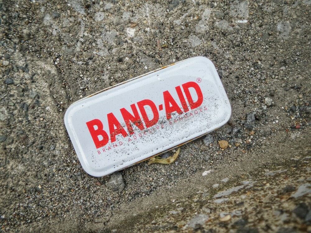 Image of a tin with the word Band Aid written on top 
