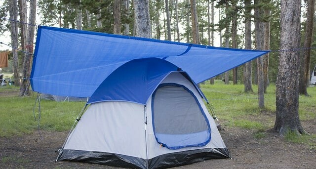 Secured tarp sheltering the tent