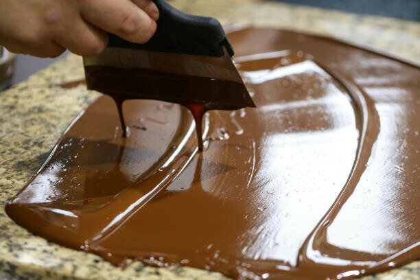 Learn How To Make A Homemade Viennetta Ice Cream Dessert image 5 chocolate being tempered spread out on work surface frosted fusions