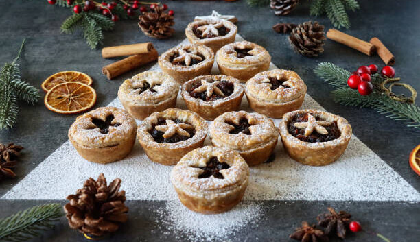 20 Festive Winter Ice Cream Recipe Ideas image 1 several mince pies displayed in a christmas tree pattern with christmas decorations frosted fusions