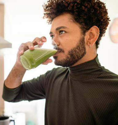 Revitalise And Refresh The Ultimate Detox Green Smoothie image 6 man drinking a green smoothie in glass frosted fusions
