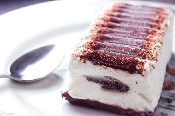 Learn How To Make A Homemade Viennetta Ice Cream Dessert image 2 viennetta ice cream dessert on a plate with silver spoon close up frosted fusions