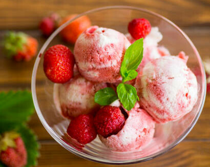 Classic Ice Cream Desserts image 3 strawberry ice cream in glass dish with fresh strawberries frosted fusions