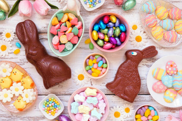 Easter Eggs-travaganza Homemade Easter Egg Ice Cream Ideas image 2 chocolate easter bunnies with a selection of sweeties in bowls and scattered frosted fusions