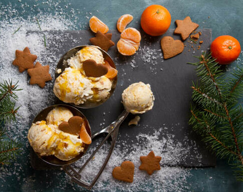 Thanksgiving Treats: Homemade Ice Cream Treats to Sweeten Your Celebration image 1 scoops of satsuma ice cream with satsumas and segments gingerbread vookies and pine tree branches frosted fusions