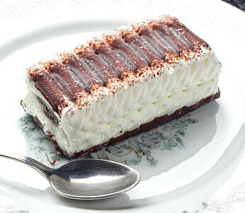 Learn How To Make A Homemade Viennetta Ice Cream Dessert image 3 viennetta ice cream dessert on a plate with silver spoon side angle showing waves of cream frosted fusions