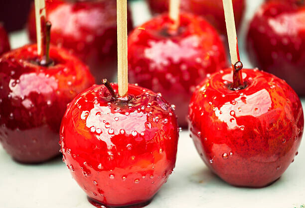 Cosy Homemade Ice Cream And Seasonal Recipes To Welcome Autumn image 2 red sticky toffee apples lined up frosted fusions