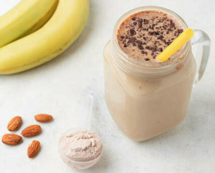 The Power Of Fat-Burning Smoothies image 7 cocoa banana and almonds with glass of smoothie frosted fusions