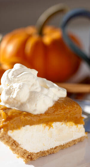 20 Festive Winter Ice Cream Recipe Ideas image 5 pumpkin pie with ice cream and pumpkin in the background frosted fusions