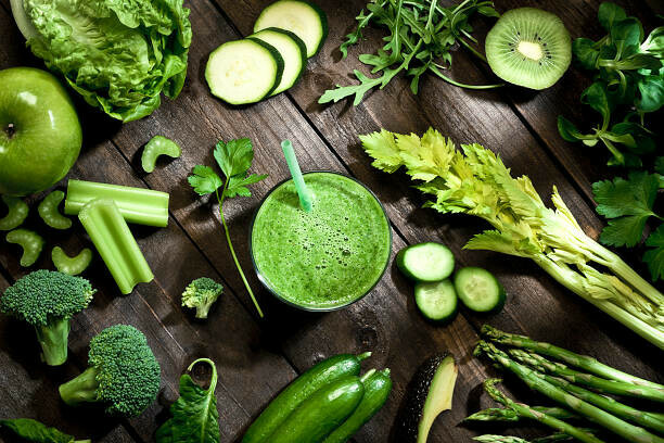 Revitalise And Refresh The Ultimate Detox Green Smoothie image 4 green smoothie amongst lots of green vegetables frosted fusions