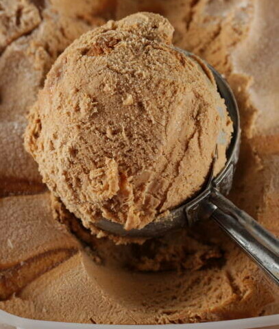 Homemade Cinnamon & Churros Ice Cream Spice and Crispy Comfort image 4 scoop of Cinnamon ice cream with cinnamon dusted over frosted fusions