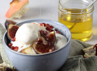 Homemade Fig And Honey Ice Cream Recipe image 4 bowl of ice cream with sliced figs and a jar of honey in the background frosted fusions