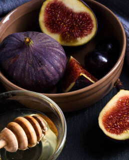 Homemade Fig And Honey Ice Cream Recipe image 3 sliced figs with a honey drizzler frosted fusions