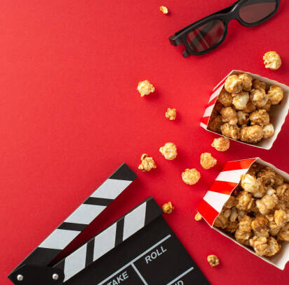 Transform Movie Nights With Delicious Homemade Popcorn Ice Cream image 6 movie clip board boxes of popcorn and 3d glasses red background top view frosted fusions