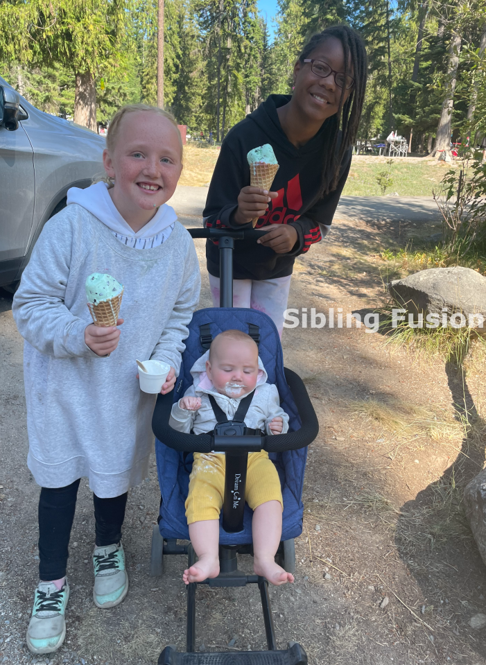 Girls enjoy ice cream with baby in the stroller