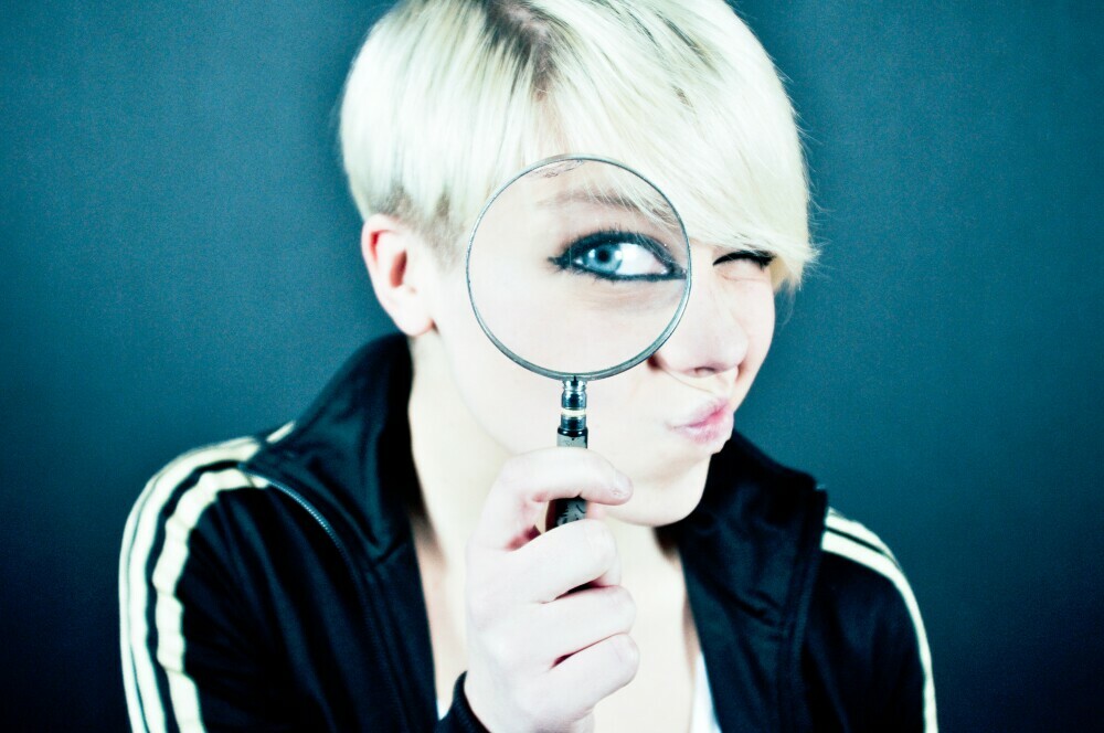 girl holding a magnifying glass