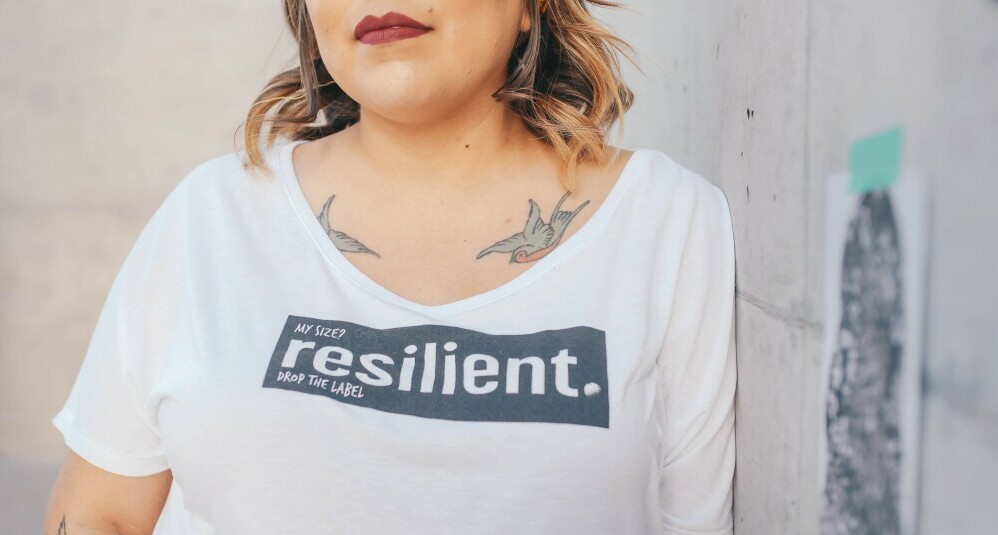 Girl wearing a T-shirt with resilient written on