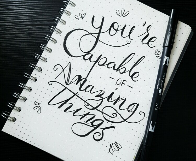 Notebook with - you're capable of amazing things written on it