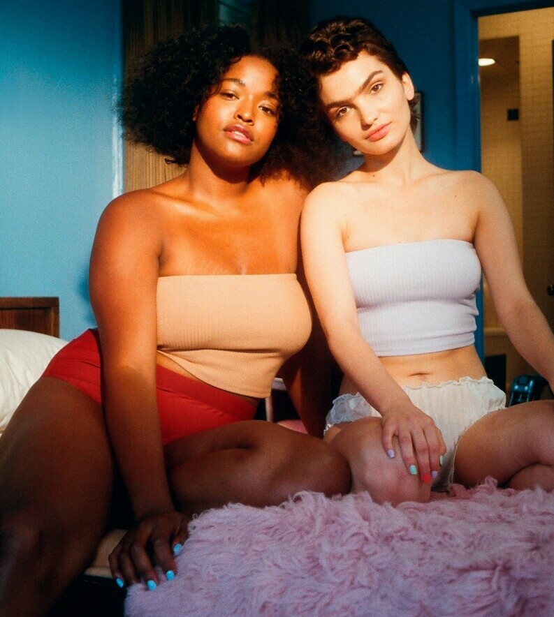 Two ladies sitting on a bed showing respect for diversity