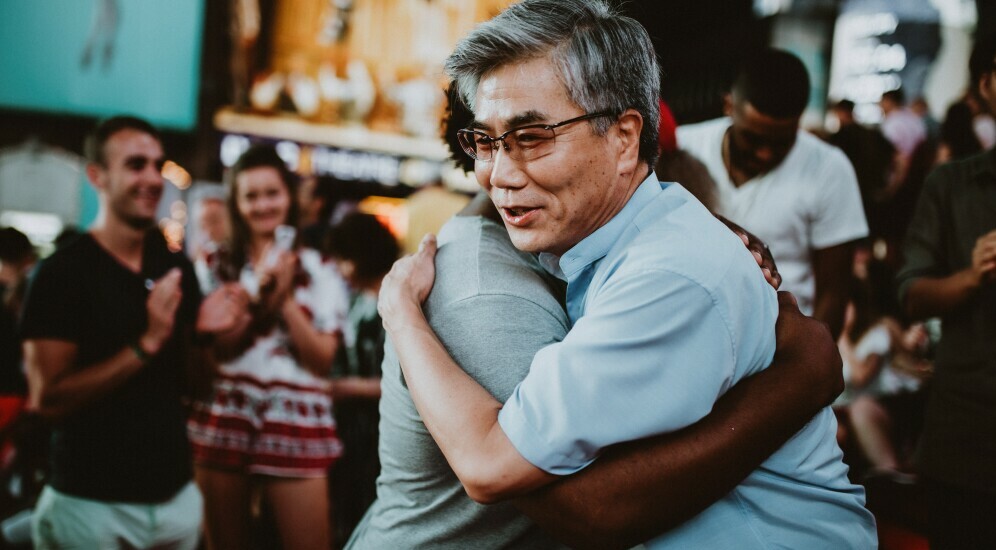 Man hugging woman