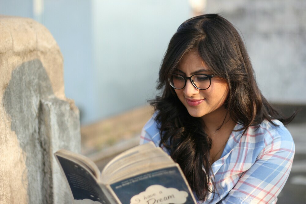 Girl reading a book smiling