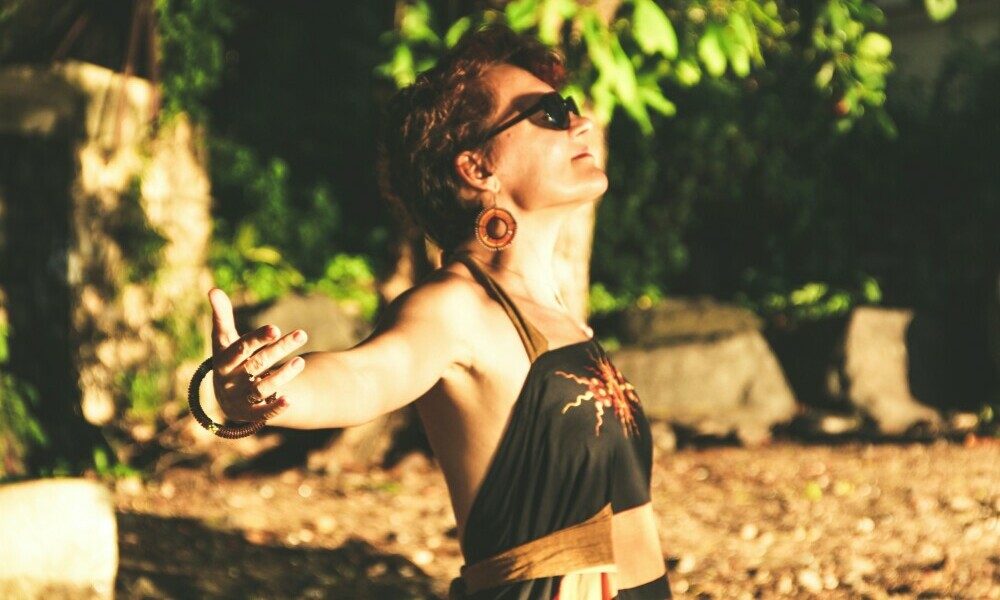 A woman in an embracing posture enjoying the sun