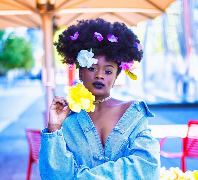 Black girl with a flower in hand 