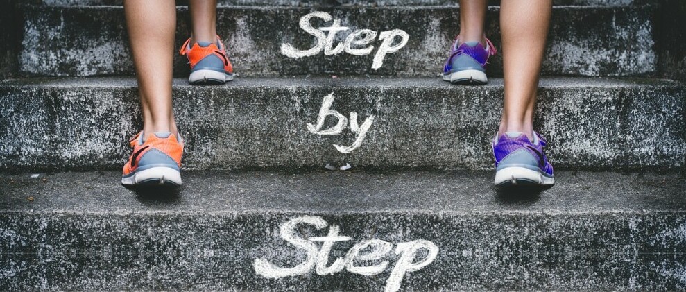 two sets of pair of feet racing up a staircase with the words step by step written on it  