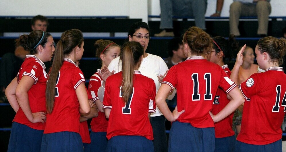 A team of girls listening to their coach