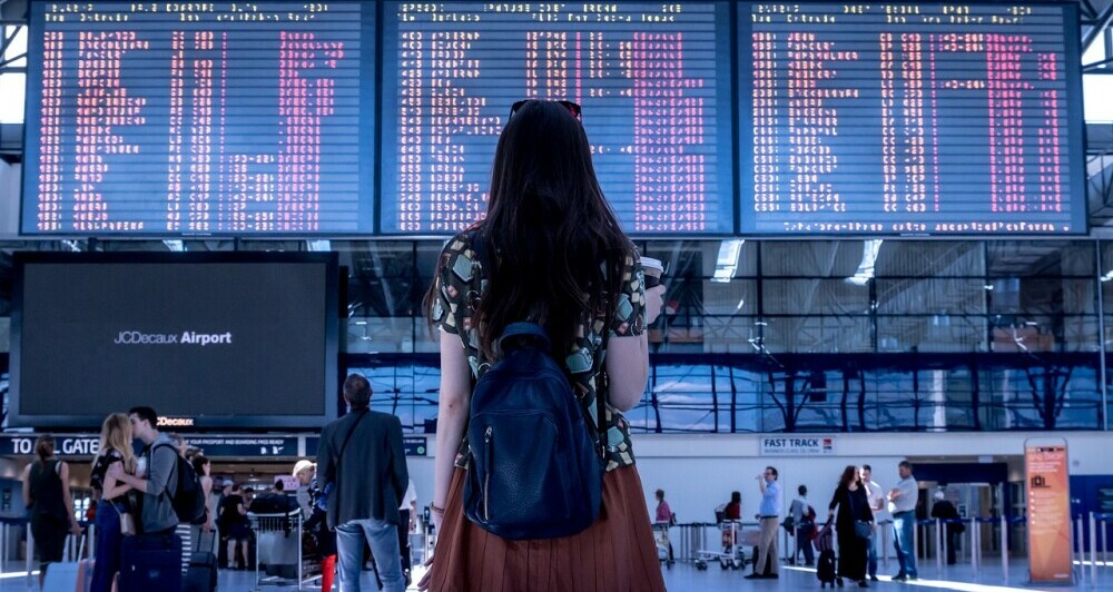 Girl looking at an infomation screen at an airport