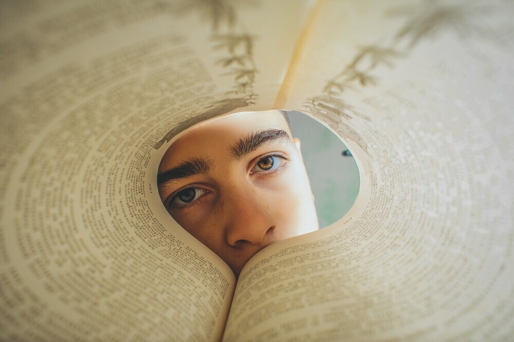 Person looking through a folded book