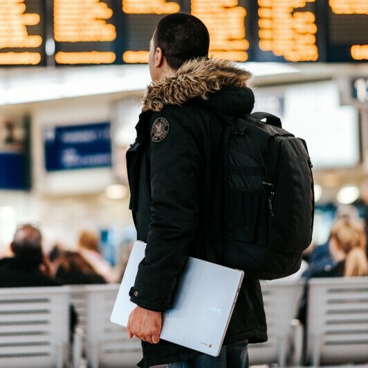 man wearing backpack to travel