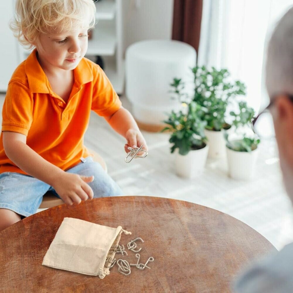 Picture of young child with parent or grandparent playing with metal puzzles for kids