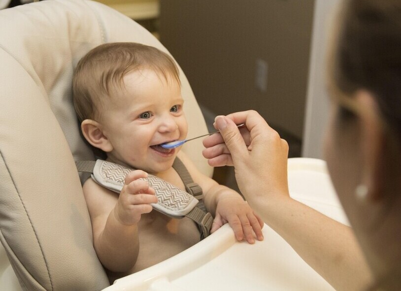 Bowl of iron-fortified baby cereal with feeding spoon