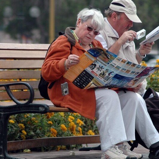 people reading on a bench