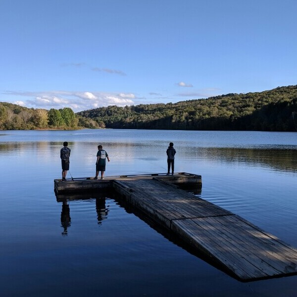 people on a deck of a lake