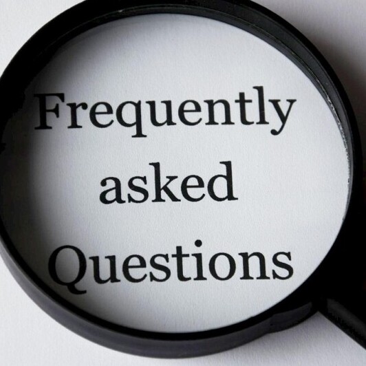 Frequently Asked Questions under a magnifying glass