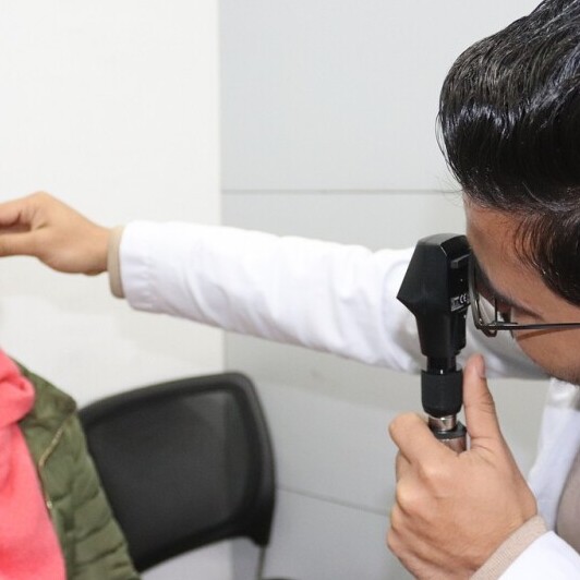girl getting  eye exam bydoctor