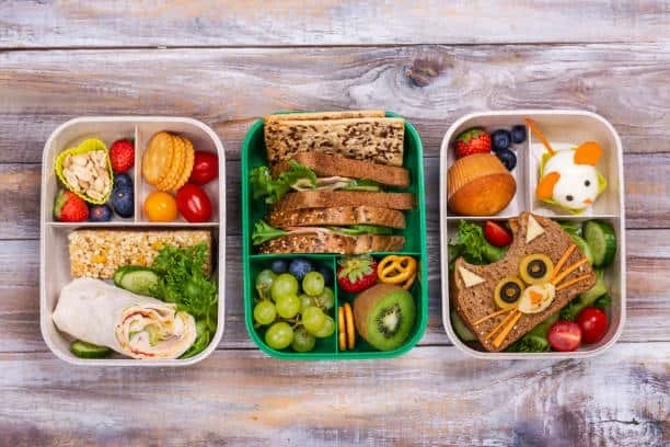 Colorful healthy lunchboxes filled with fresh vegetables, fruit, wraps, and balanced meals for busy families.