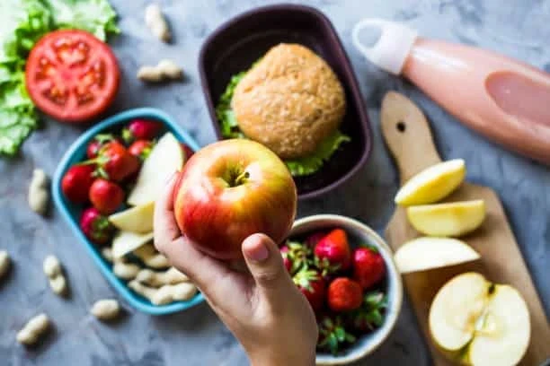 Healthy breakfast meal prep with fresh fruit, overnight oats, nuts, and nutritious ingredients for busy families.