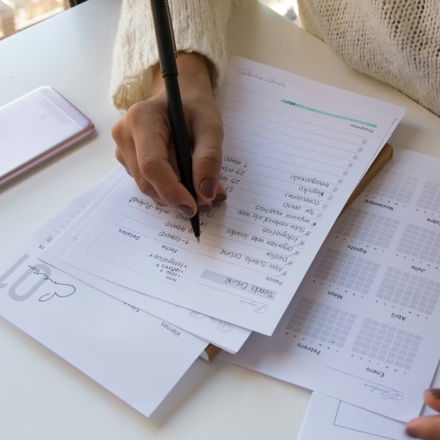 Image of hand with pen writing notes