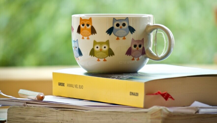 Cup of coffee on a book