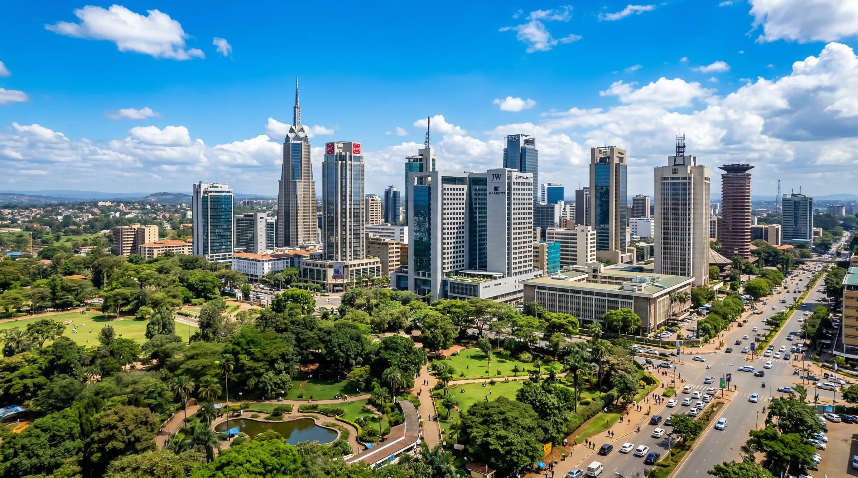 A city skyline showing Nairobi's growing business district, with office buildings and green spaces, under a bright blue sky.